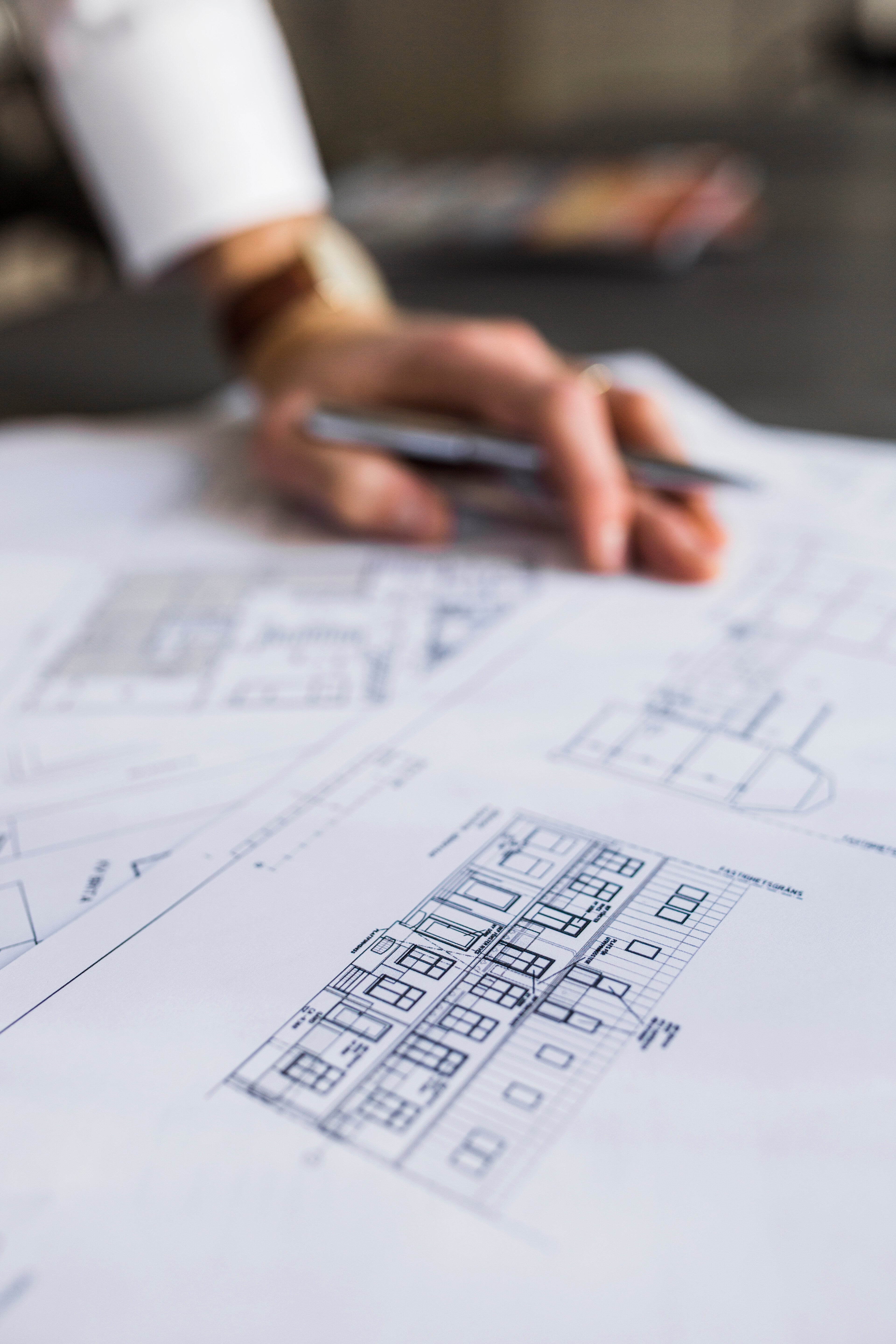 Architect reviewing building plans during the design phase where Lightning Safety Solutions coordinates lightning protection layout and compliance.