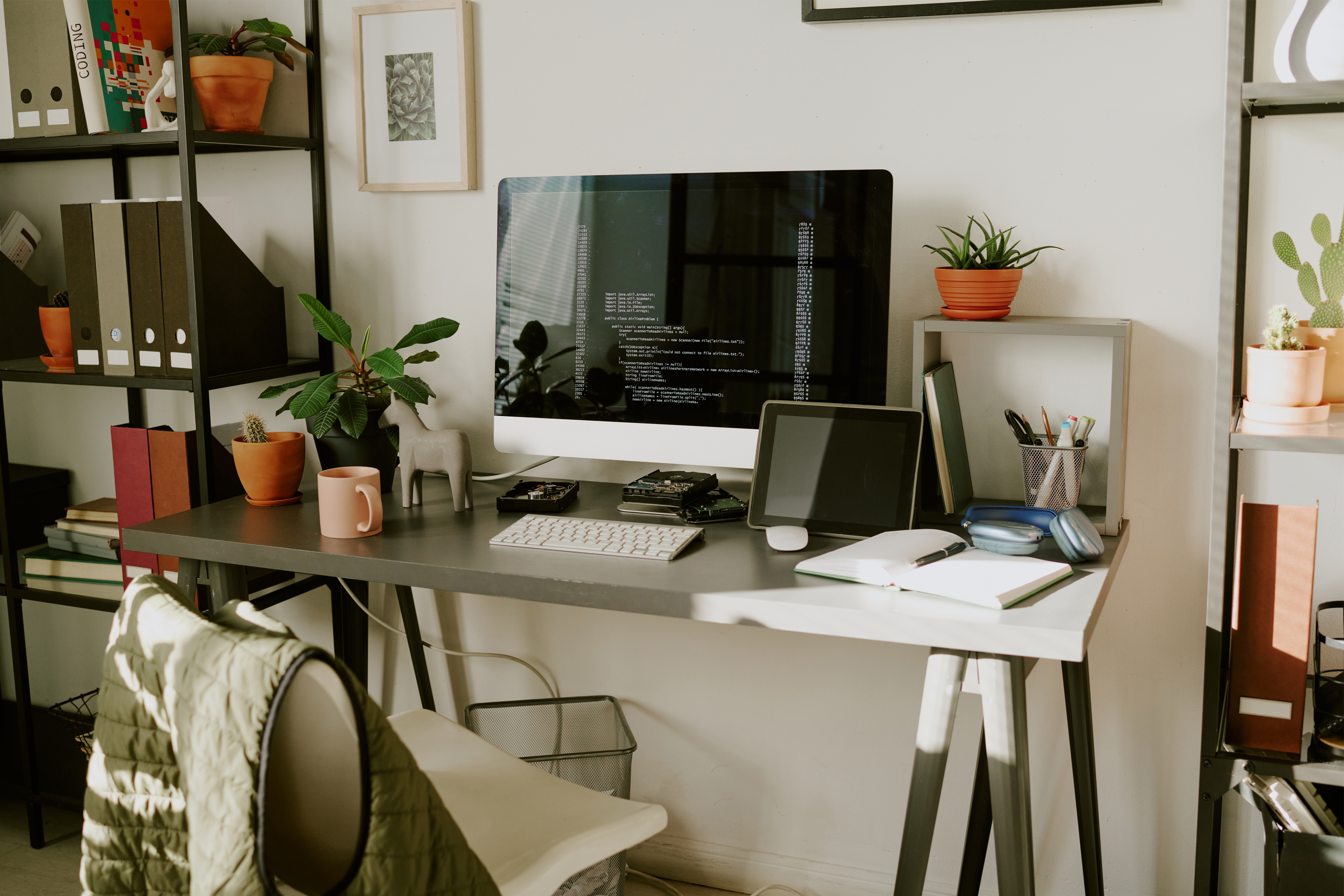 Home office with computer, tablet, and electronics vulnerable to power surges, highlighting the need for whole-home surge protection by Lightning Safety Solutions.