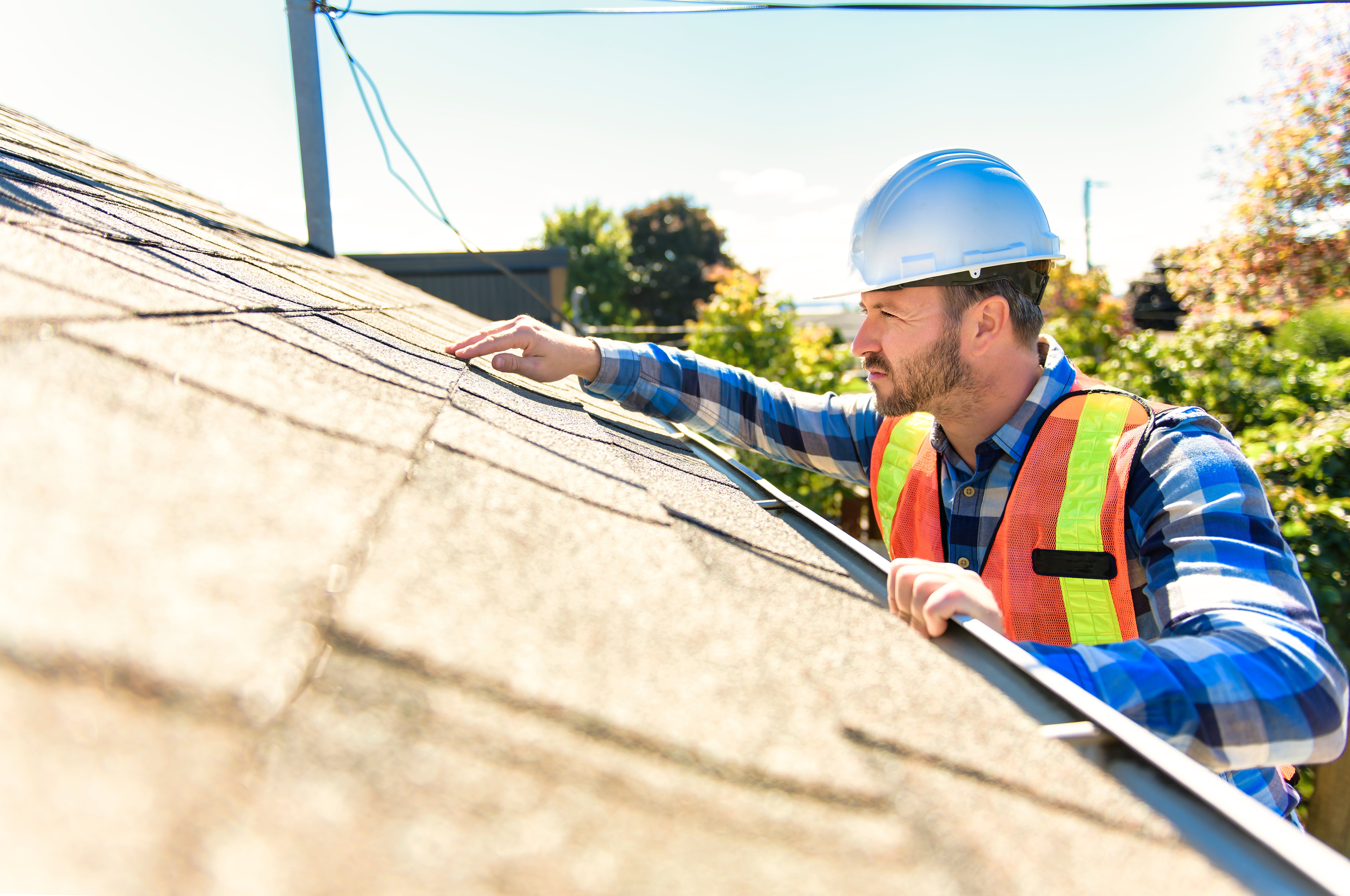 Technician inspecting a residential roof in North Texas as part of Lightning Safety Solutions’ process before lightning protection installation.